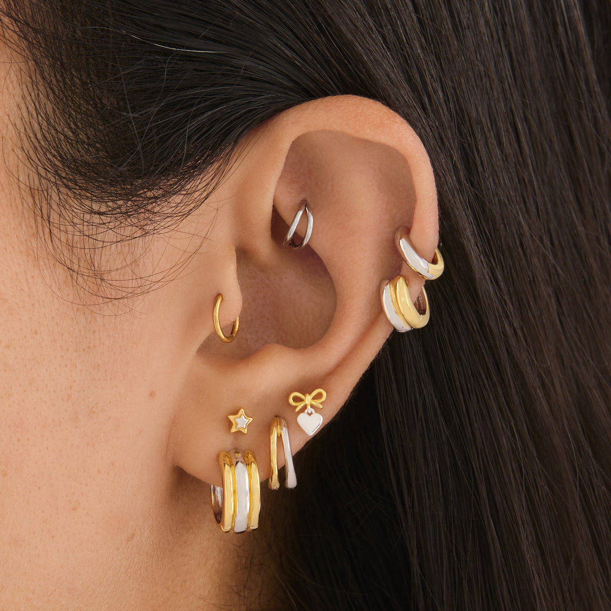 on ear featuring a Chunky two tone hoop with ridges of gold and silver [hover] color:null|gold/silver