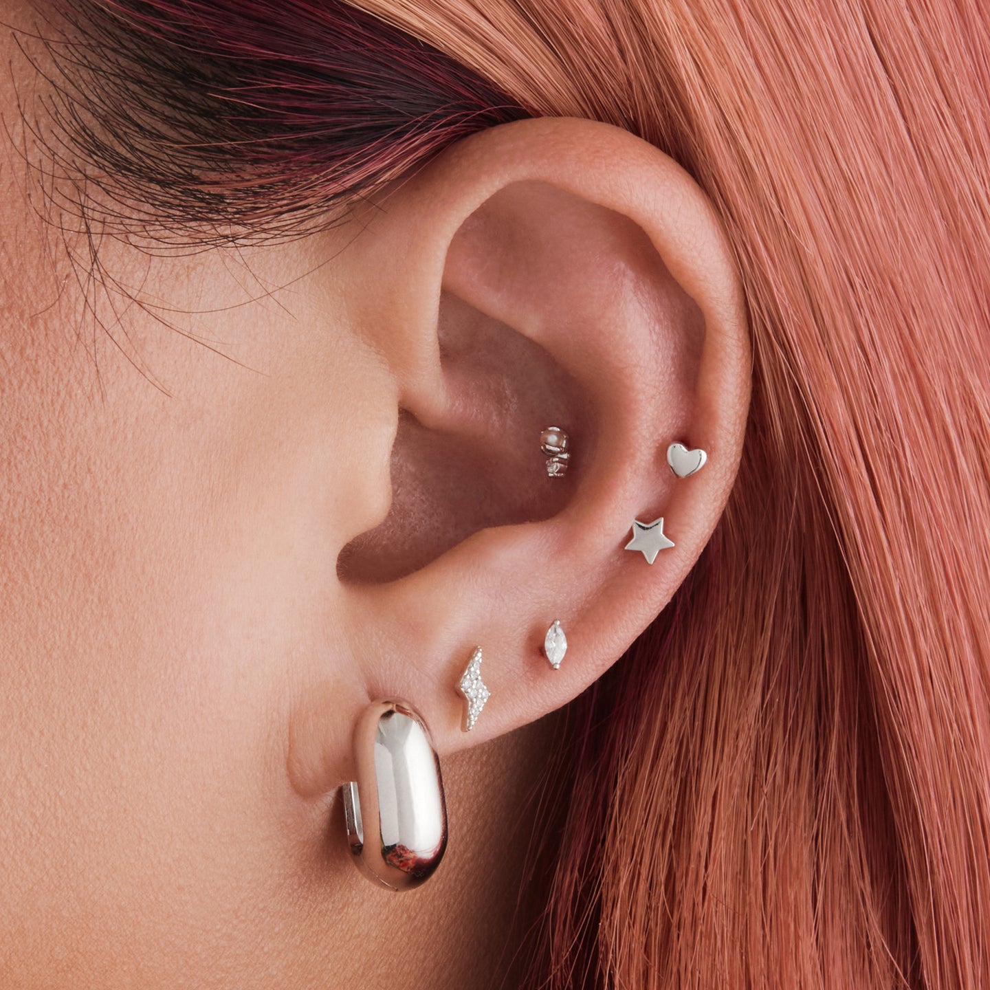 An image of a silver, chunky, square shaped huggies on ear. [hover] color:null|silver
