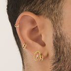 on ear featuring a gold clicker with a cz bezel accent stone [hover] color:null|gold/clear