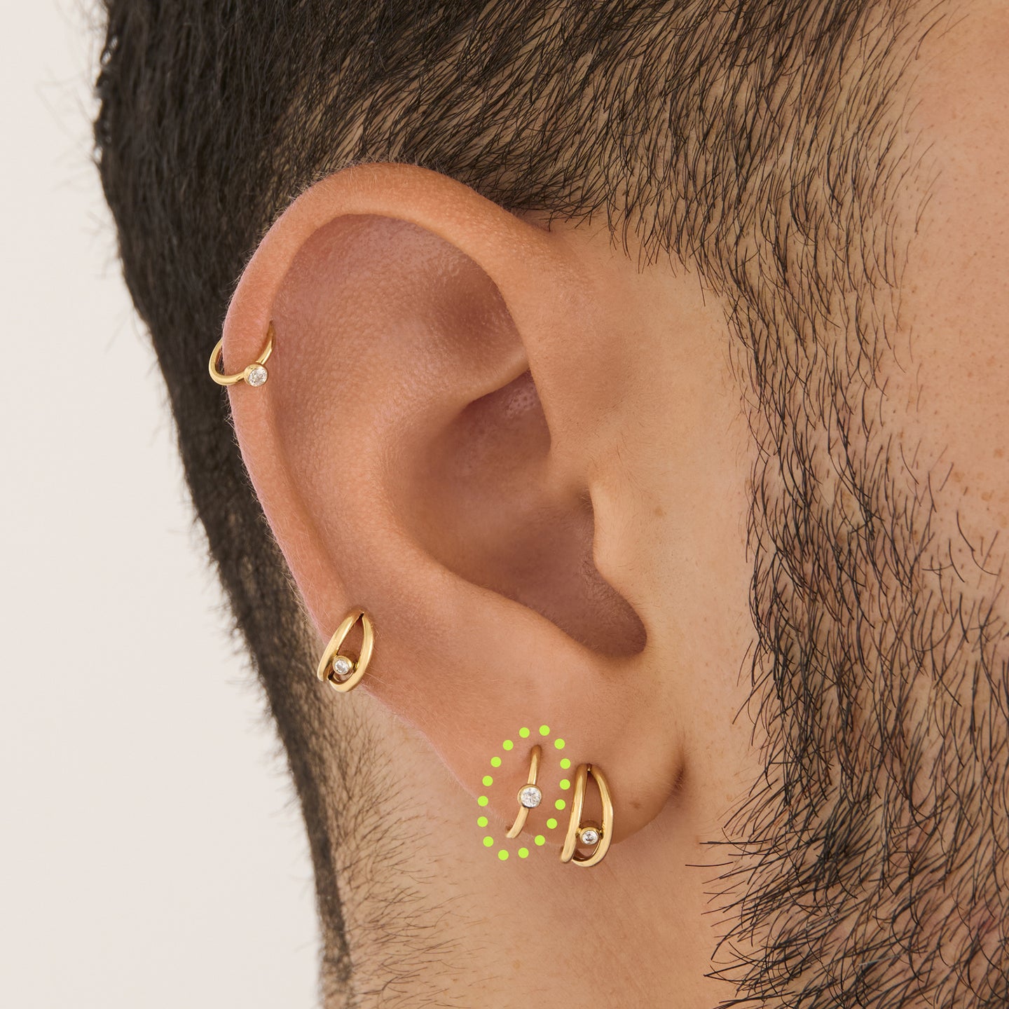 on ear featuring a gold clicker with a cz bezel accent stone [hover] color:null|gold/clear