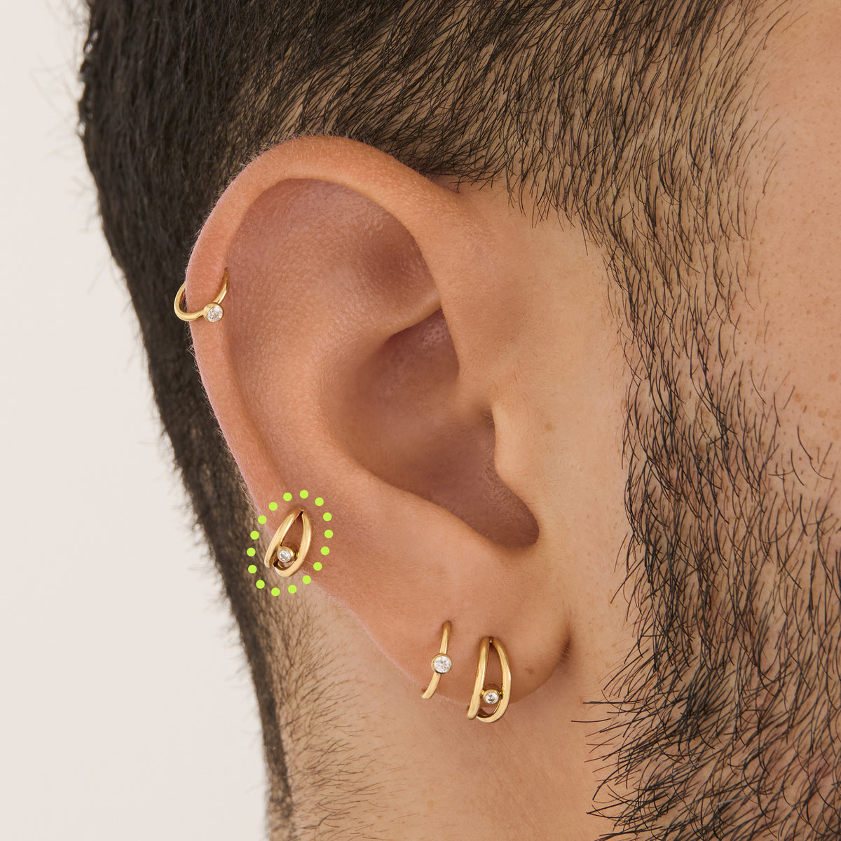 on ear featuring a double clicker with a small bezel stone accent in gold [hover] color:null|gold/clear
