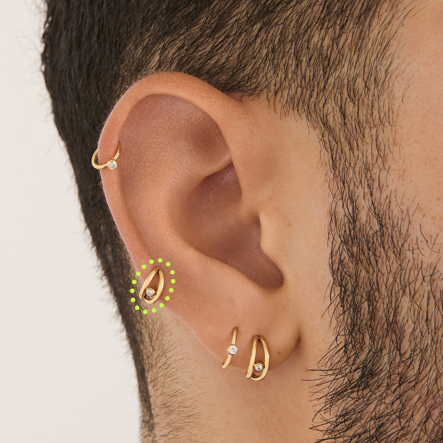 on ear featuring a double clicker with a small bezel stone accent in gold [hover] color:null|gold/clear