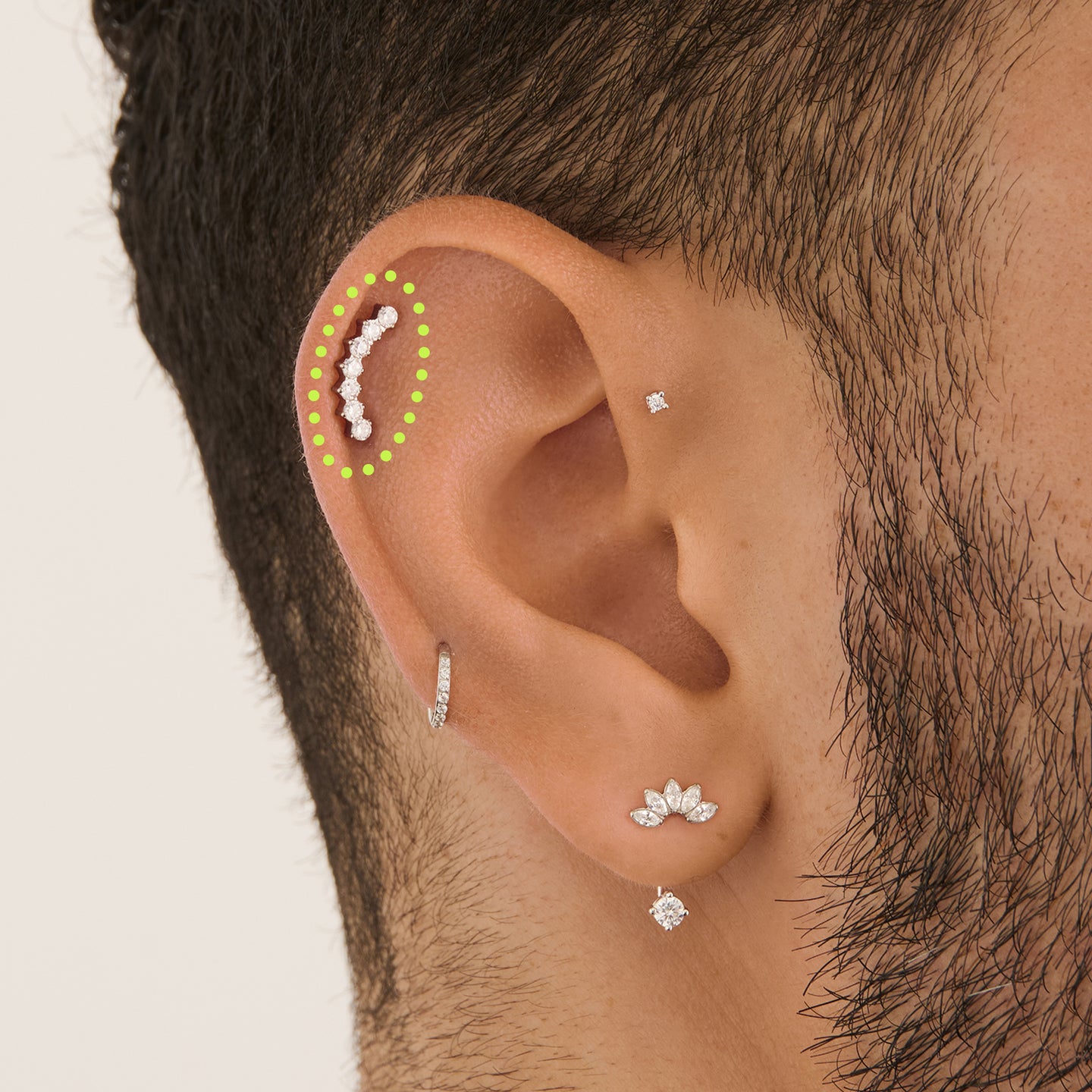 on ear featuring a flatback stud with a curved row of cz stones in silver [hover] color:null|silver/clear