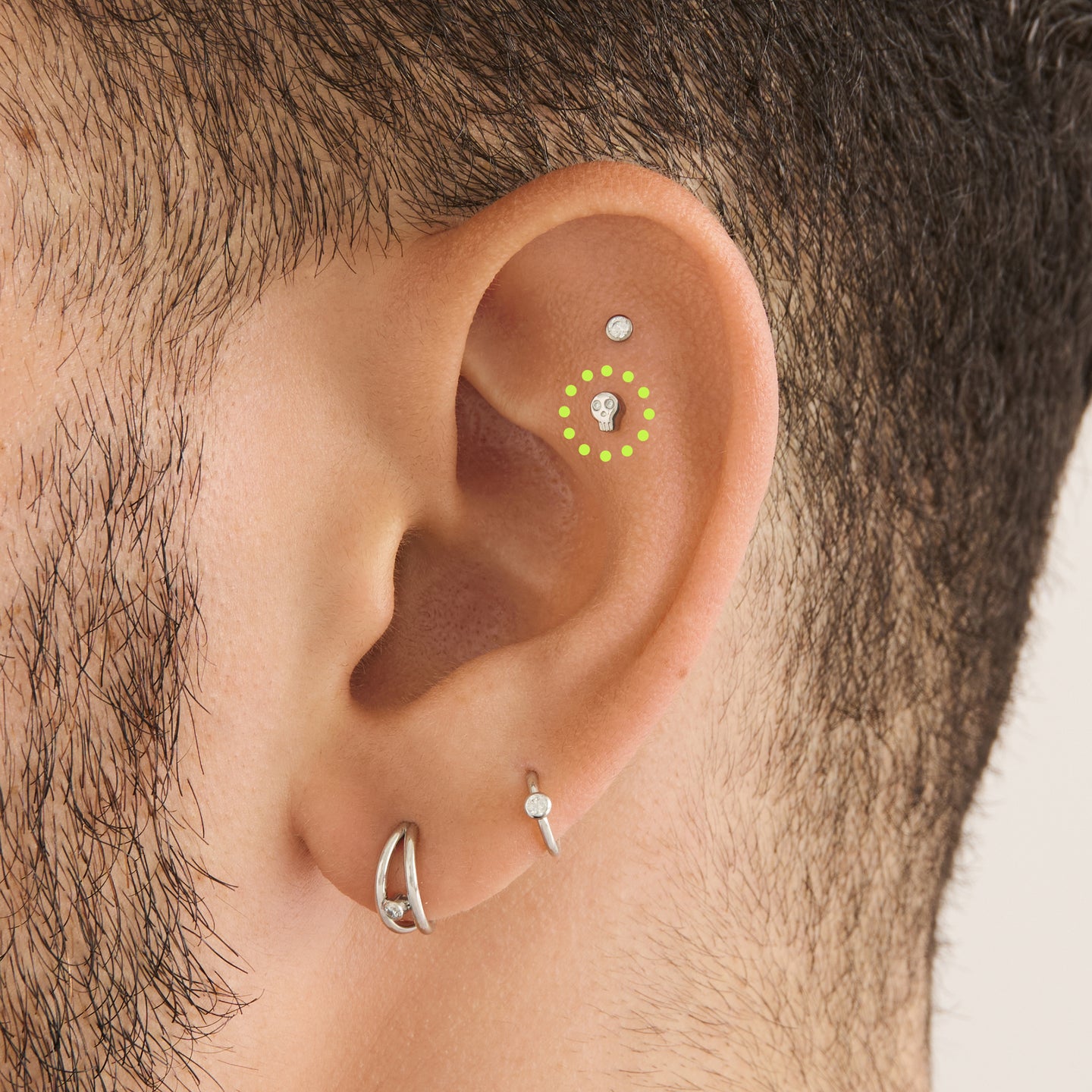 on ear featuring a micro cz skull stud in silver with cz accent eyes [hover] color:null|silver/clear