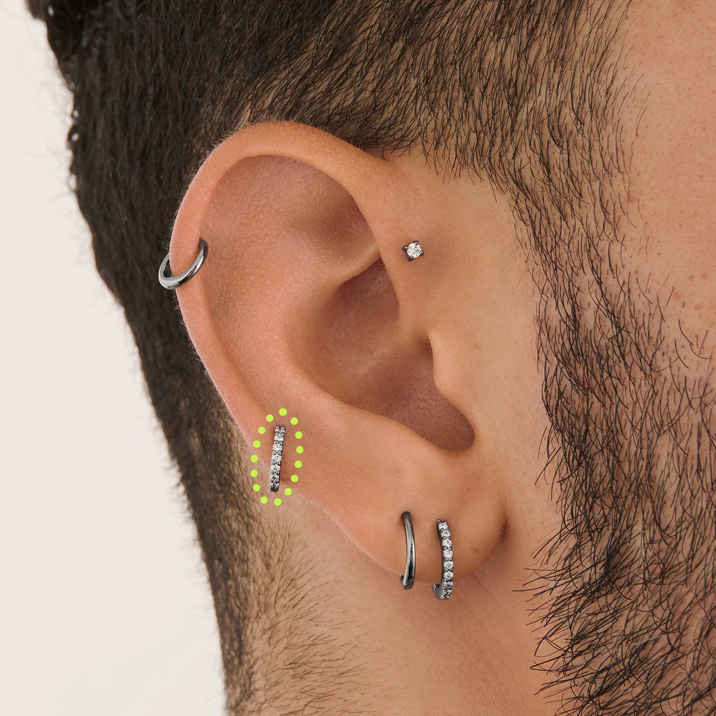 on ear featuring a micro pave huggie in gun metal with clear stones [hover] color:null|gunmetal