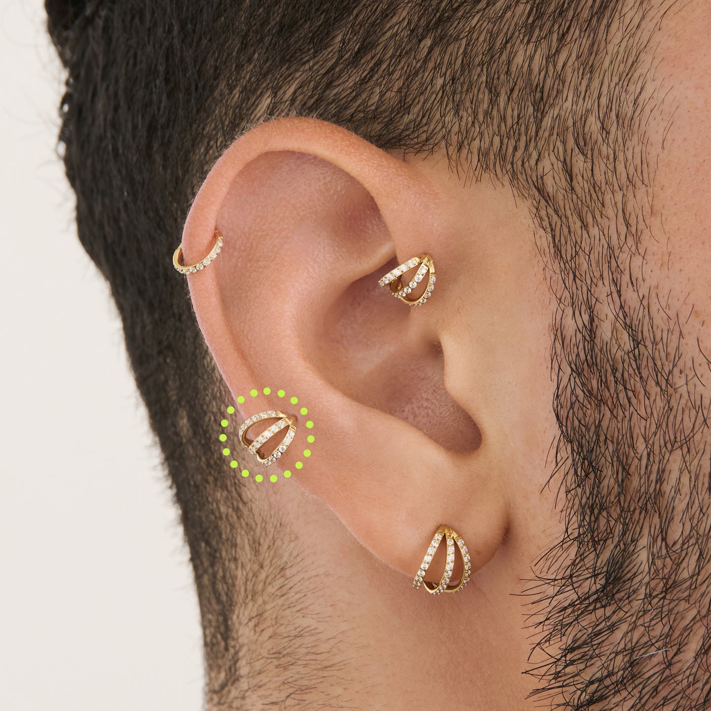 on ear featuring a gold triple pave clicker with cz stone accents [hover] color:null|gold/clear