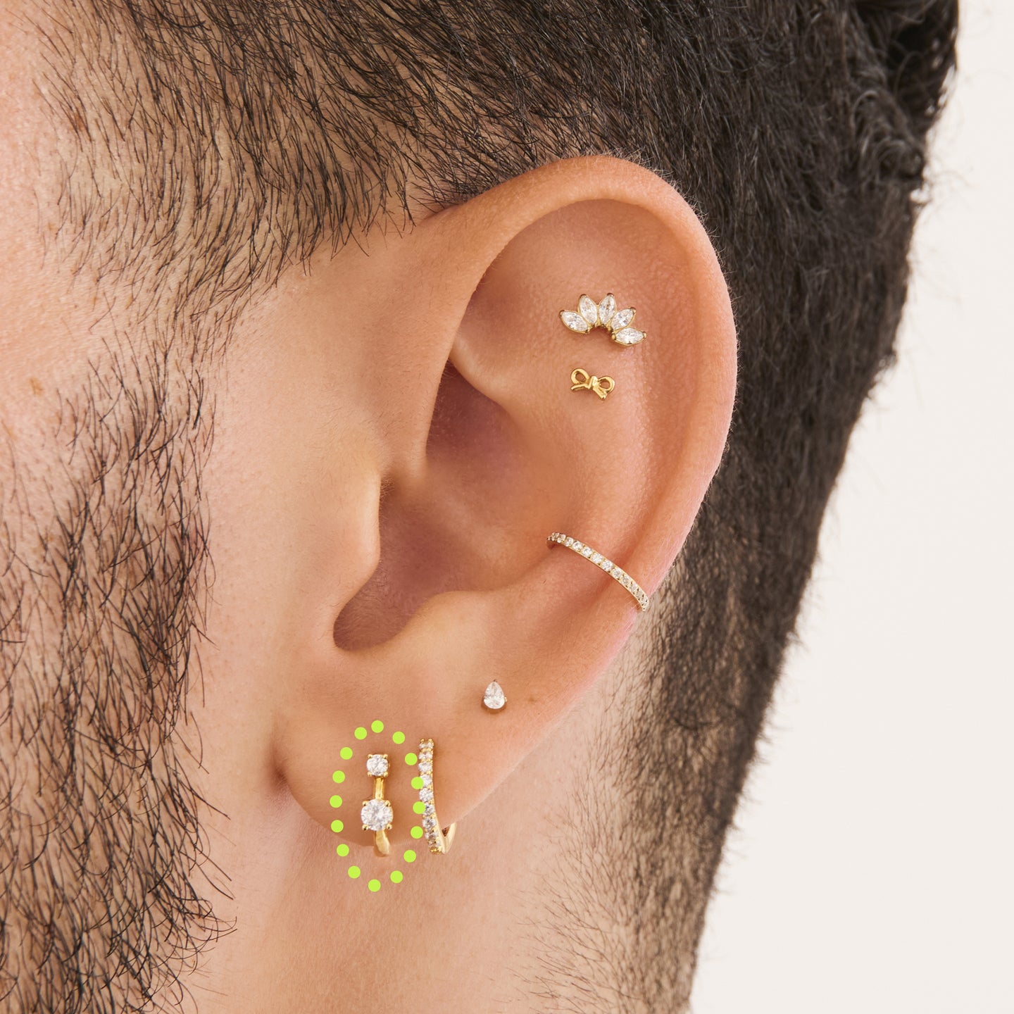 on ear featuring a mini huggie in gold with 2 mini cz stones [hover] color:null|gold