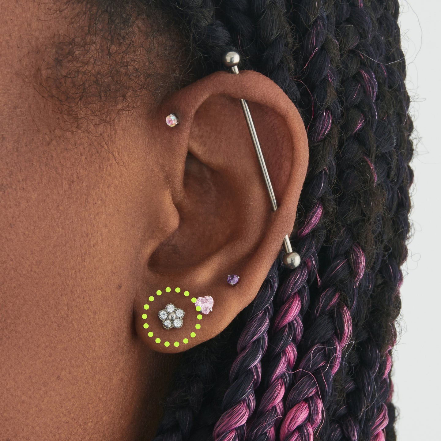 on ear featuring a silver titanium stud in the shape of a daisy made with 5 petal CZs [hover] color:null|titanium/clear