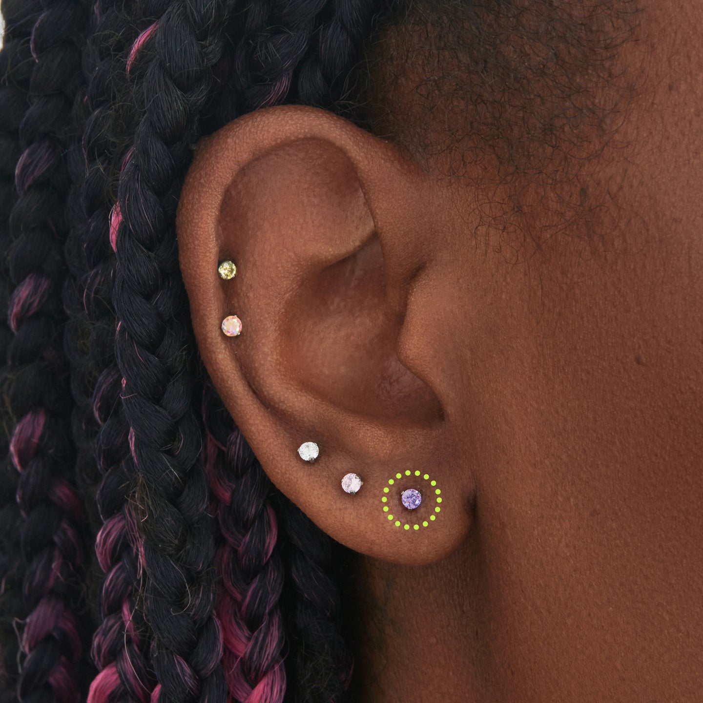 on ear featuring a titanium flatback stud with a 2.5mm purple cz stone that comes with 2 backs in 6mm and 8mm lengths [hover] color:null|silver/purple