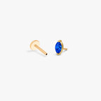 This image shows a side view of a golden titanium marquise flatback with a blue cz stone separated from labret 