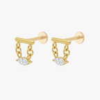 This is an image of a pair of gold toned flatback studs that have gold bars with chains hanging from both sides supporting clear, marquise cut CZ stones.  