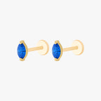 This image shows a side view of a pair of the golden titanium marquise flatback with a blue cz stone 