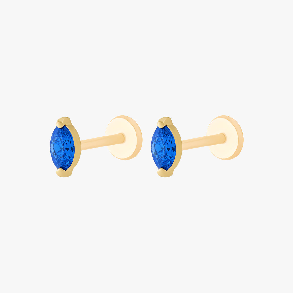 This image shows a side view of a pair of the golden titanium marquise flatback with a blue cz stone 
