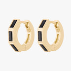 this image shows the side view of the 14k gold plated max bezel baguette huggie pair with black cz baguette stones. 