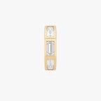 this image shows the front view of the 14k gold plated max bezel baguette huggie with clear cz baguette stones. 