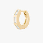 this image shows the side view of the 14k gold plated max bezel baguette huggie with clear cz baguette stones. 