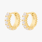 this image shows the side view of the 14k gold plated max pave spike huggie pair. this huggie pair has clear cz stones and gold spikes up and down the sides 