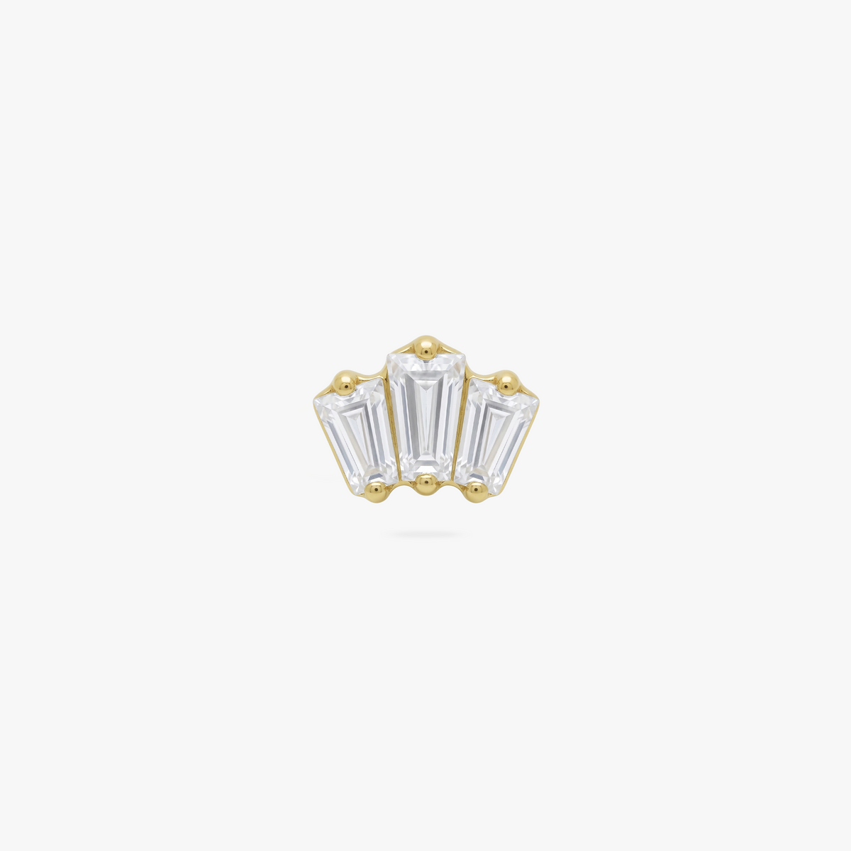 This is an image of a gold toned flatback stud that has three clear baguette cut CZs forming a crown shape. 