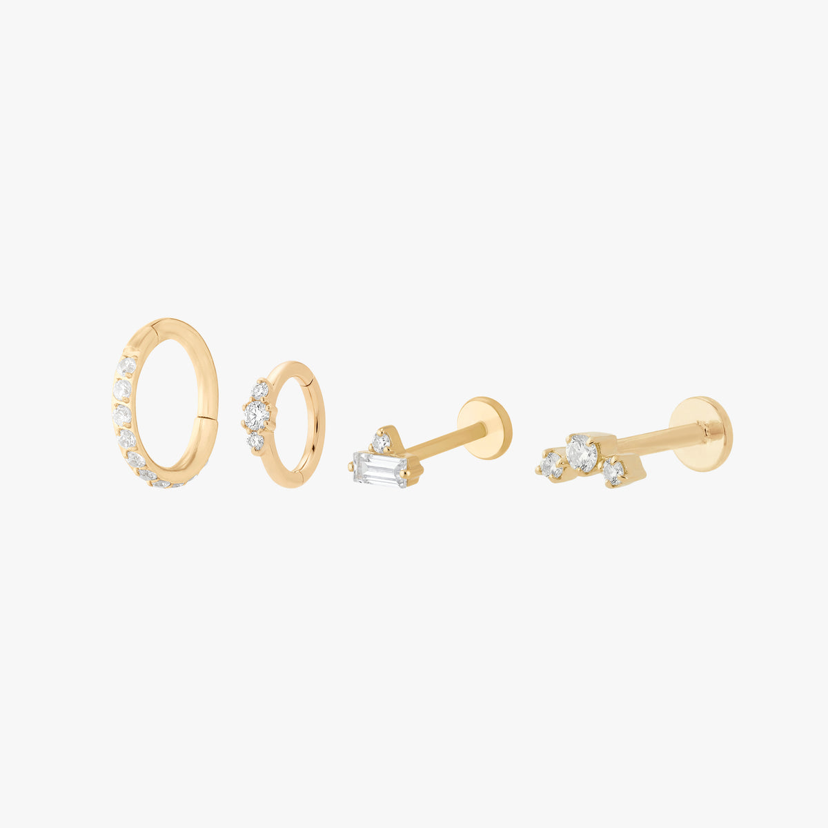 Set of gold earrings featuring 2 micro clickers with pave and 2 micro flatbacks with small cz stones 