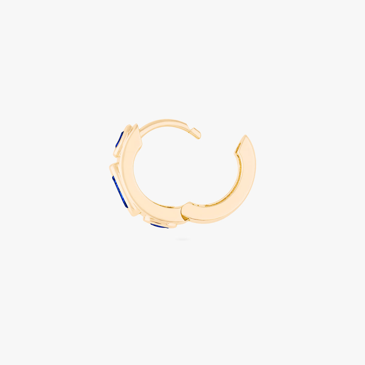 this image shows the side view of a 14k gold plated huggie with three blue circular cz stones disconnected from hinge 