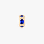 this image shows the front view of a 14k gold plated huggie with three blue circular cz stones