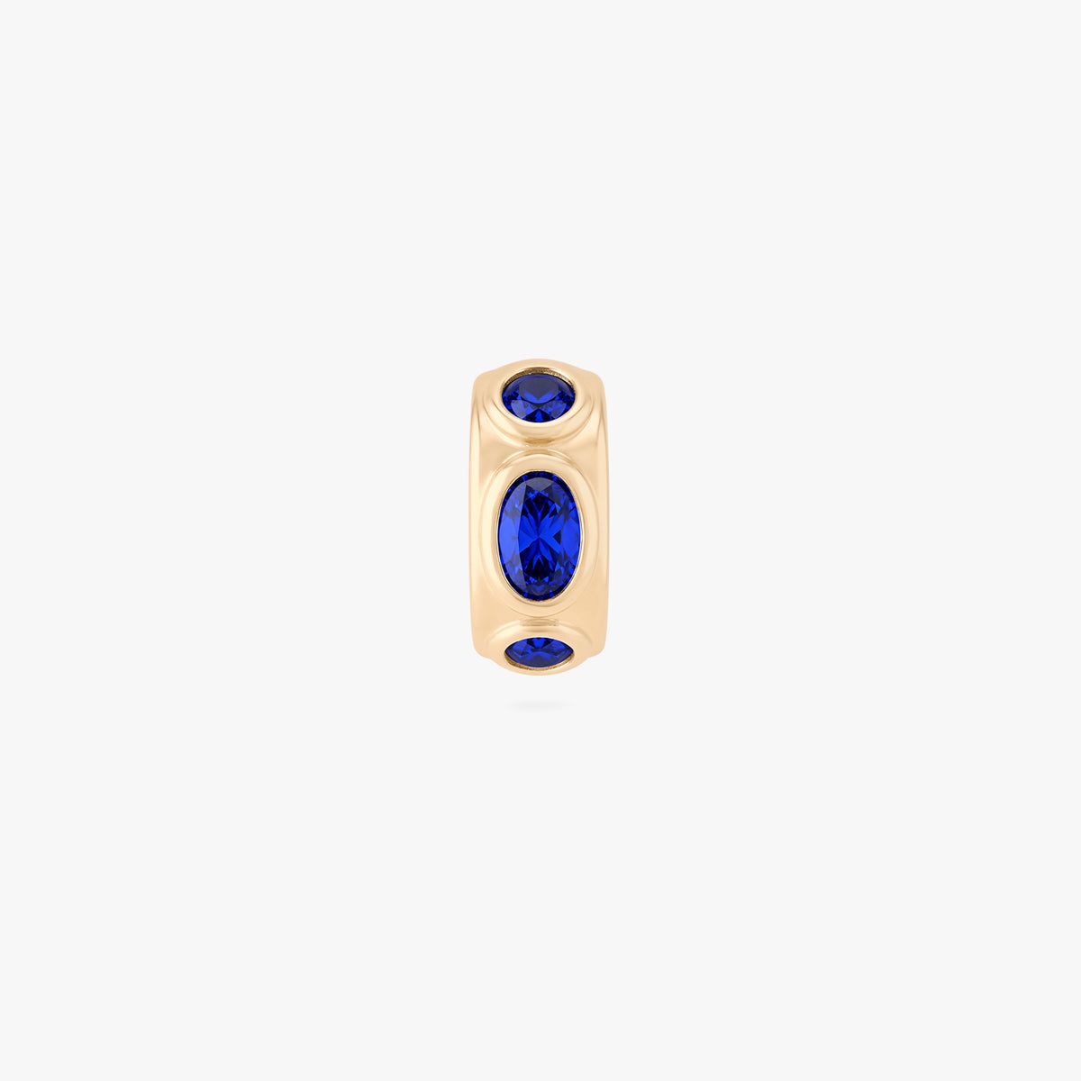 this image shows the front view of a 14k gold plated huggie with three blue circular cz stones