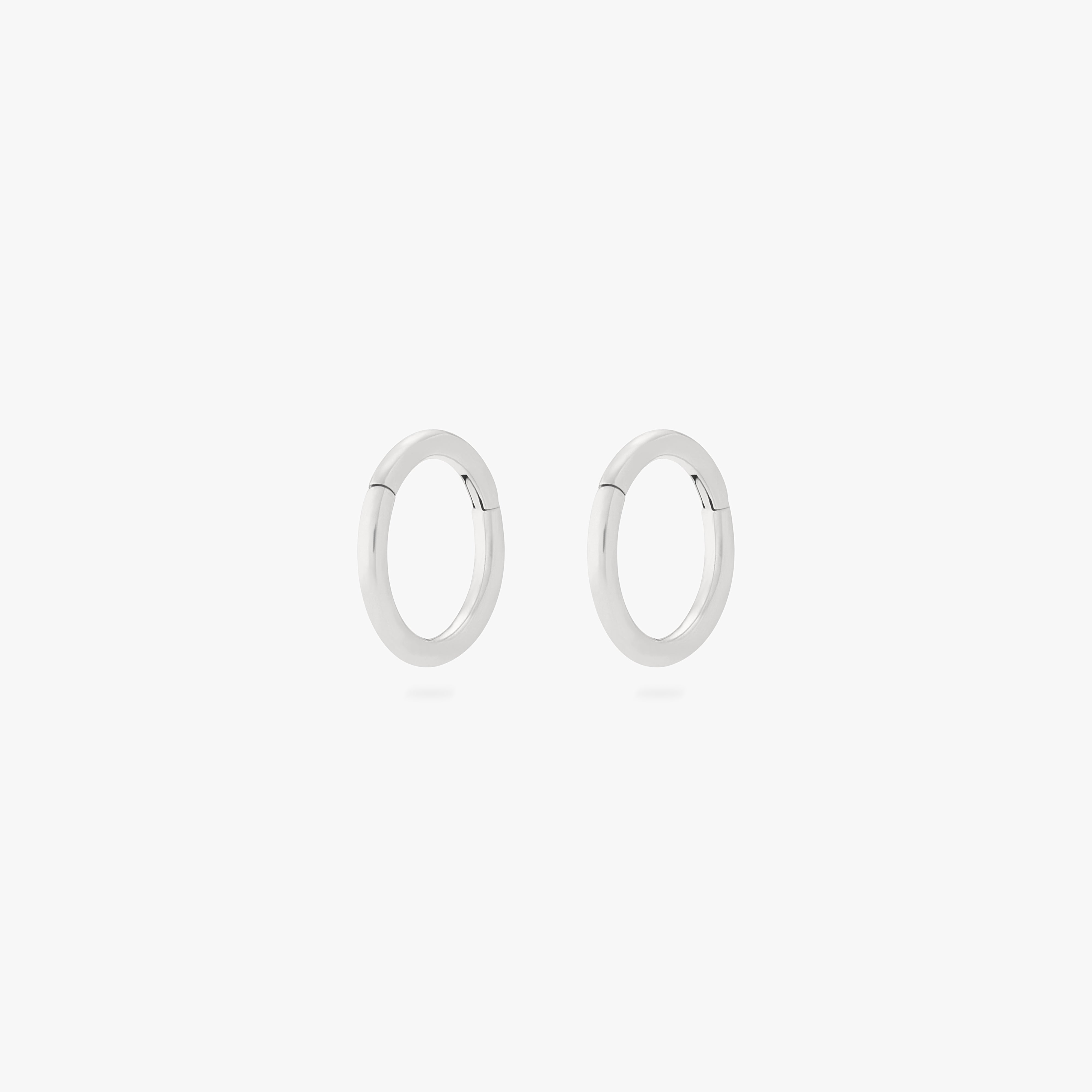 This is an image of a pair of silver clickers with 6mm inner diameters. [pair] color:null|silver