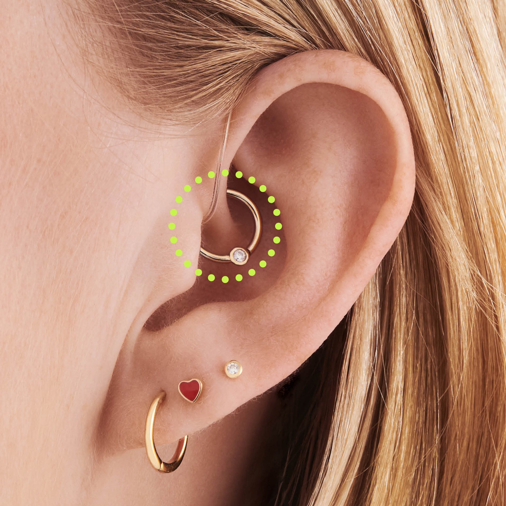 This is an image of a 14K gold clicker that is 8mm wide with a bezel set crystal CZ circled on an ear. - Alternative view 1