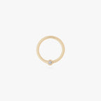 This is an image of a 14K gold clicker that has a 10mm diameter and a bezel set crystal CZ against a white background. 