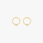 this image shows a pair of 14k gold plated titanium front face clickers with a clear cz 