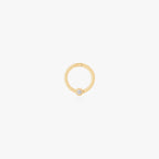 This image shows a 14k gold plated titanium front face clicker with a clear cz