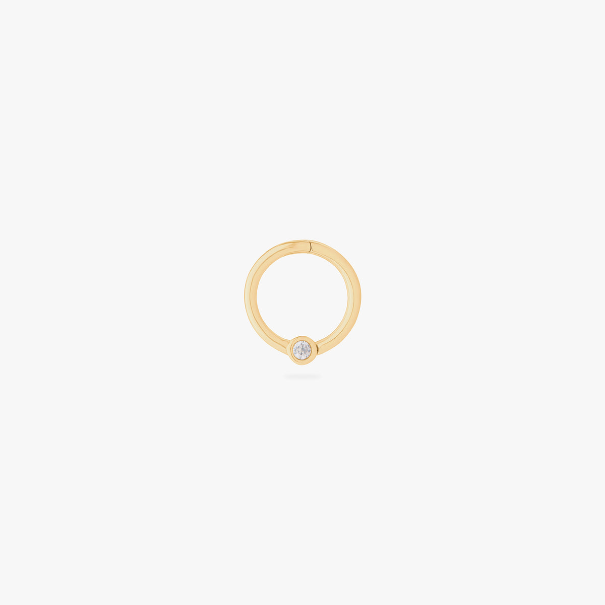 This image shows a 14k gold plated titanium front face clicker with a clear cz