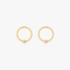 this image shows a pair of 14k gold plated titanium front face clickers with a clear cz 