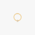 this image shows a 14k gold plated titanium front face clicker with a clear cz 