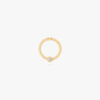 this image shows a 14k gold plated titanium front face clicker with a clear cz 
