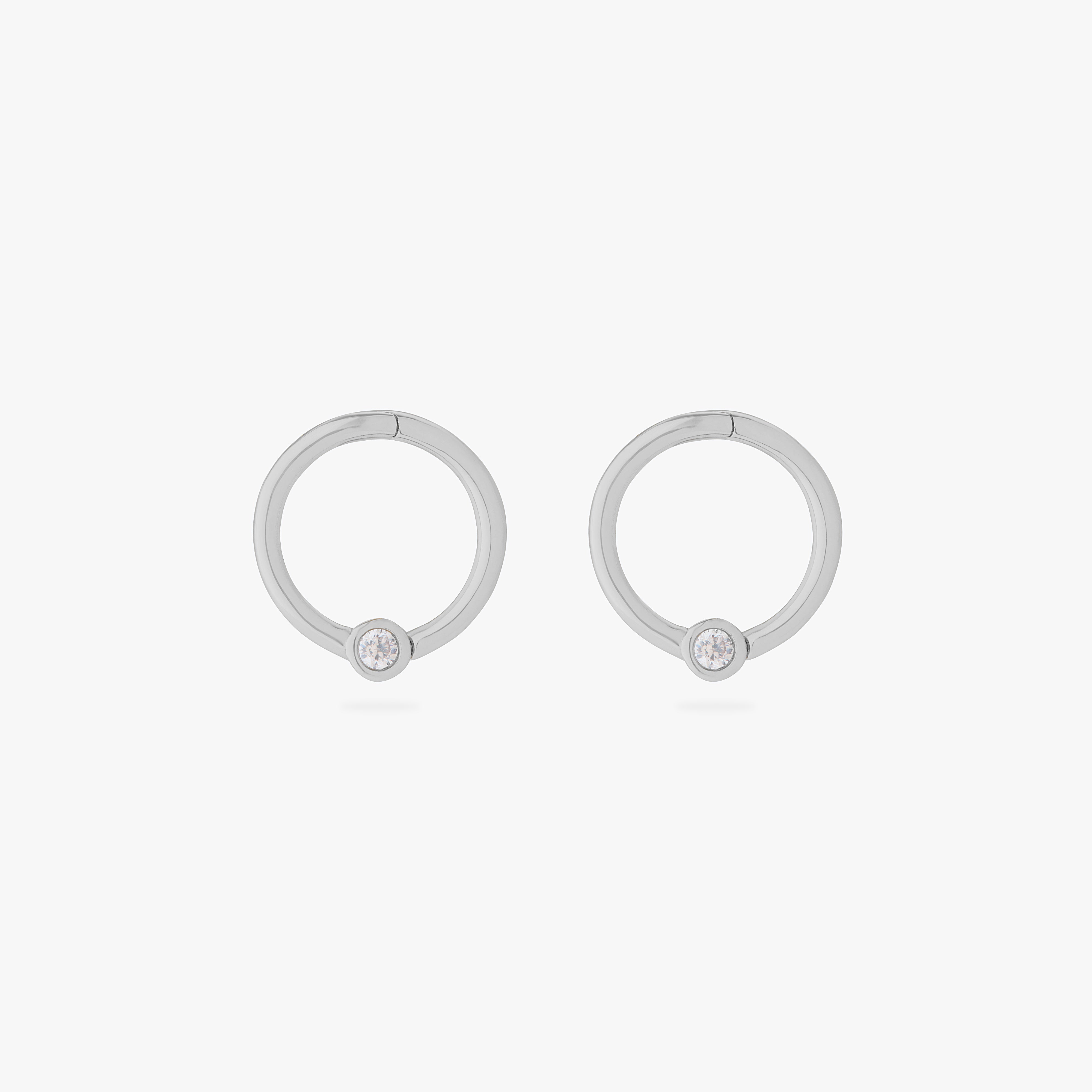 this image shows a pair of 14k white gold plated titanium front face clickers with a clear cz - Pair view