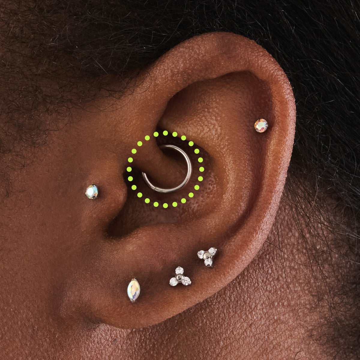 This is an image of a silver-toned titanium clicker that is 8mm wide circled on an ear. - Alternative view 1