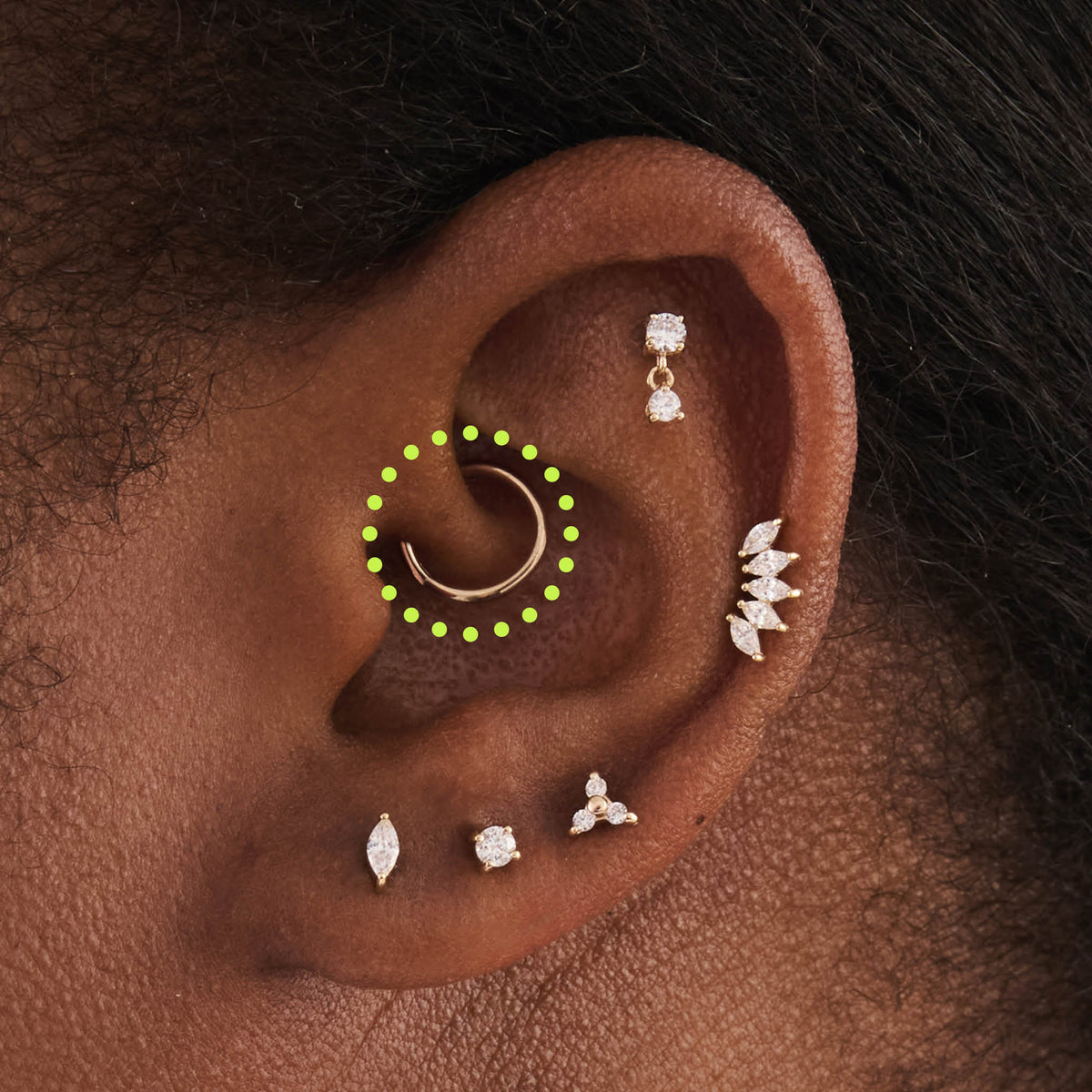This is an image of a 14K gold clicker that is 8mm wide circled on an ear.