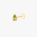 this image shows a side angle view of a Golden Titanium pear flatback with a green cz stone. 