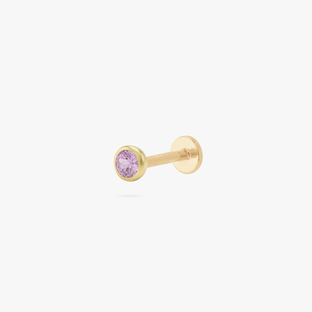 This is an image of a gold toned flatback stud with a 3mm, bezel set pink CZ stone. 