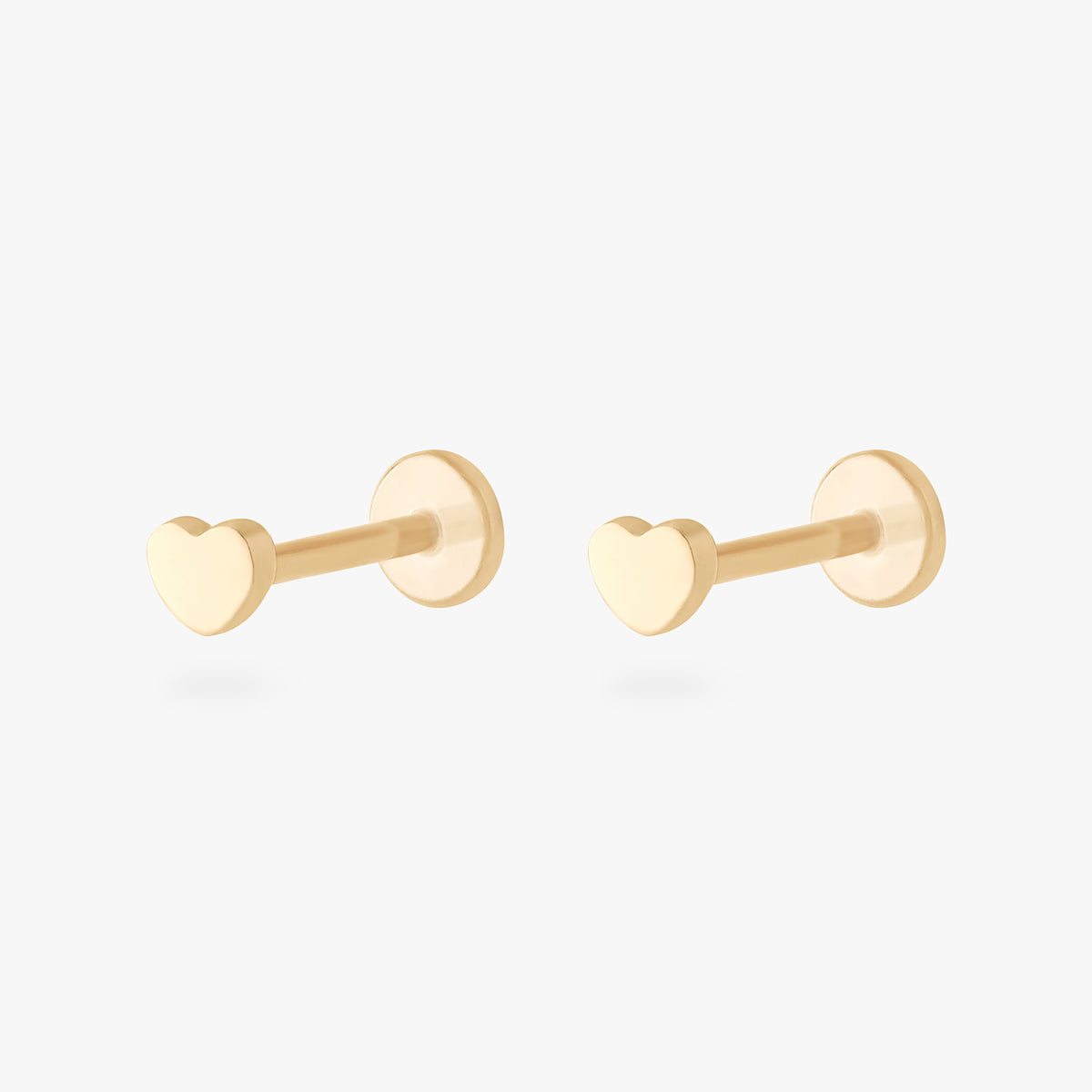 This image shows a pair of 14k yellow gold heart flatback studs 