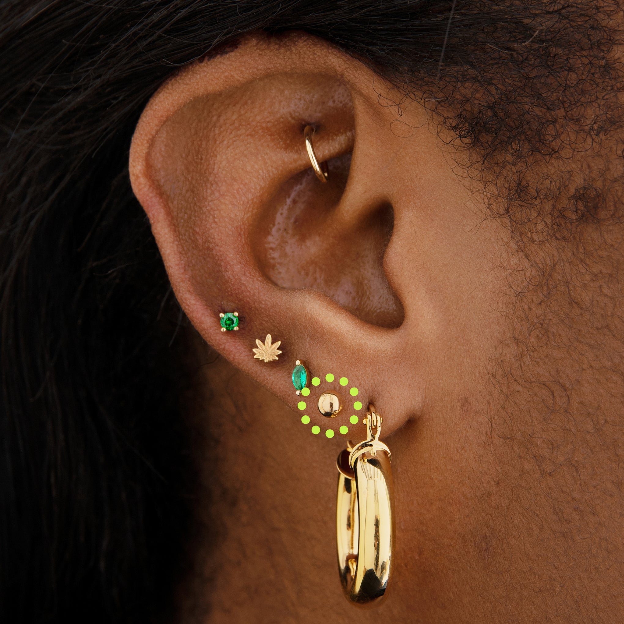 This is an image of a 14k gold flatback stud that is a solid gold ball shape on ear. [hover] color:null|14k gold