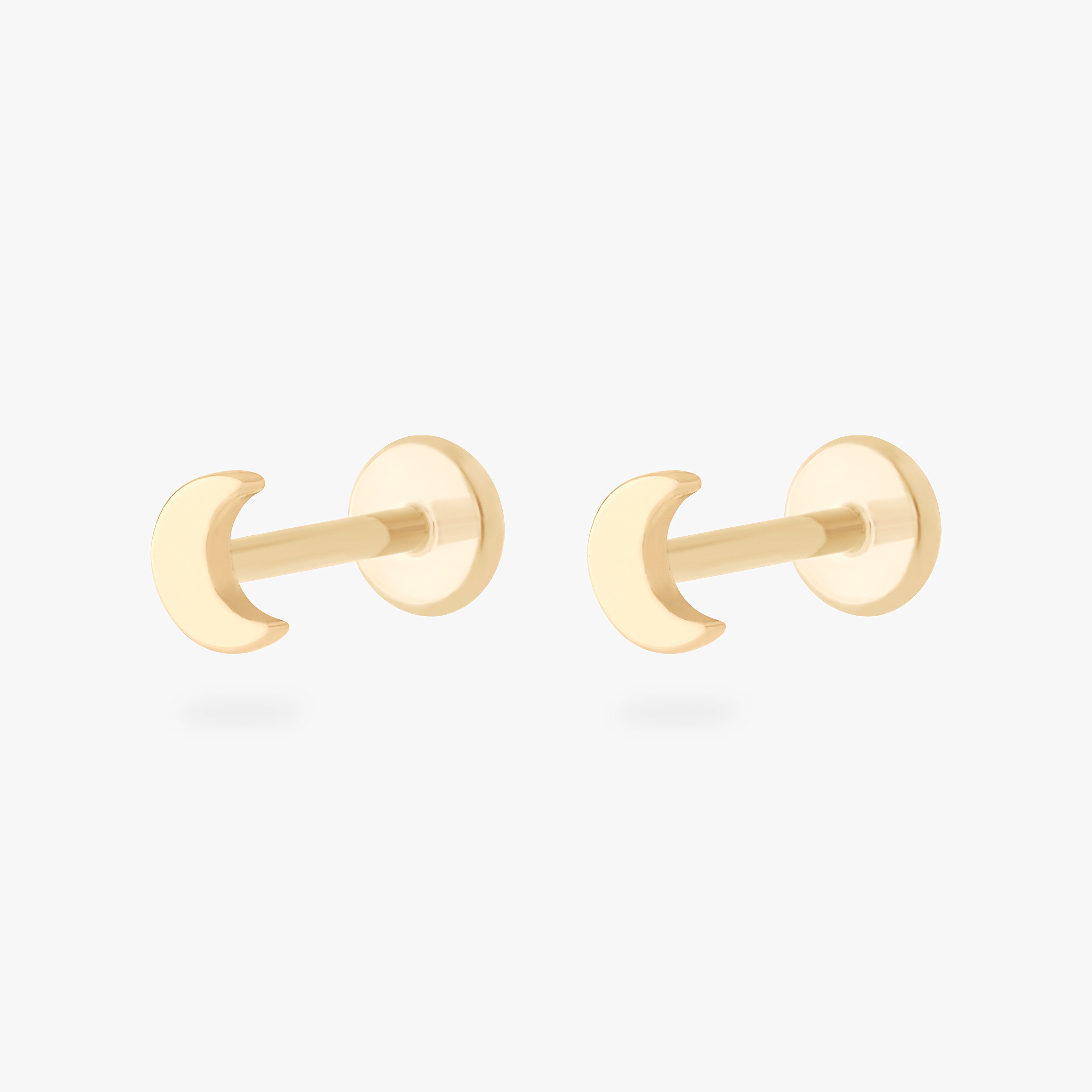 This is an image of a pair of 14k gold flatback studs in the shape of moons. [pair] color:null|14k gold