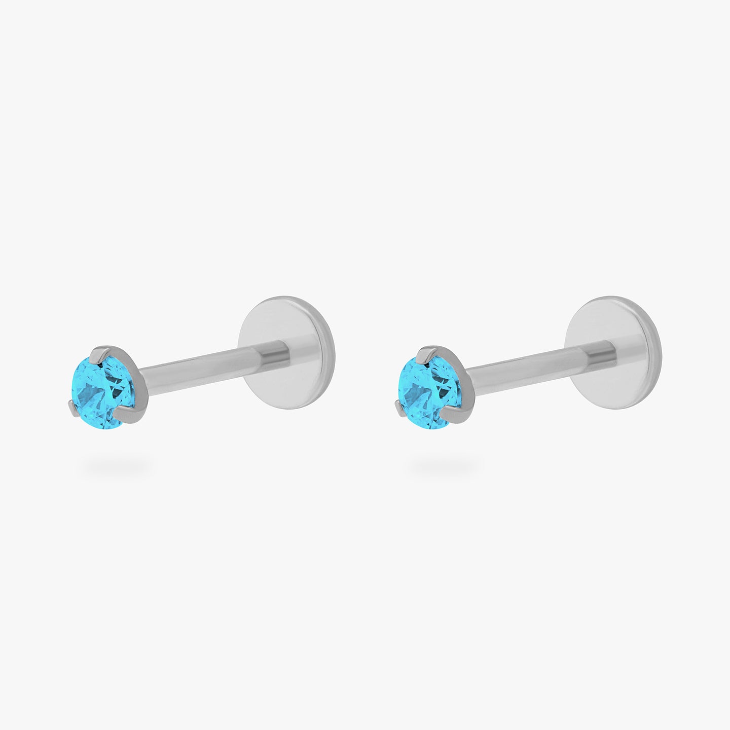 This is a pair of silver toned titanium flatback studs with mini aquamarine cz stones. [pair] color:null|aquamarine