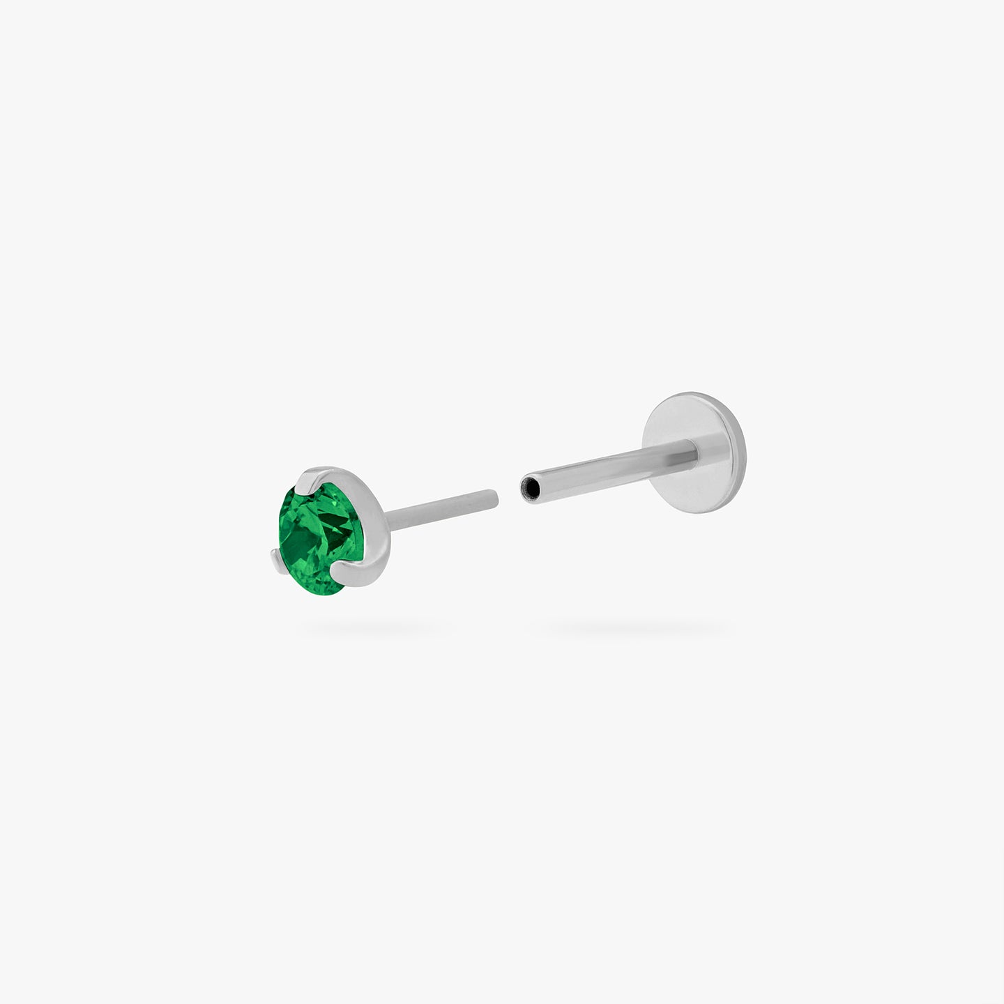 This is a silver toned titanium flatback stud with an emerald mini cz stone. color:null|emerald