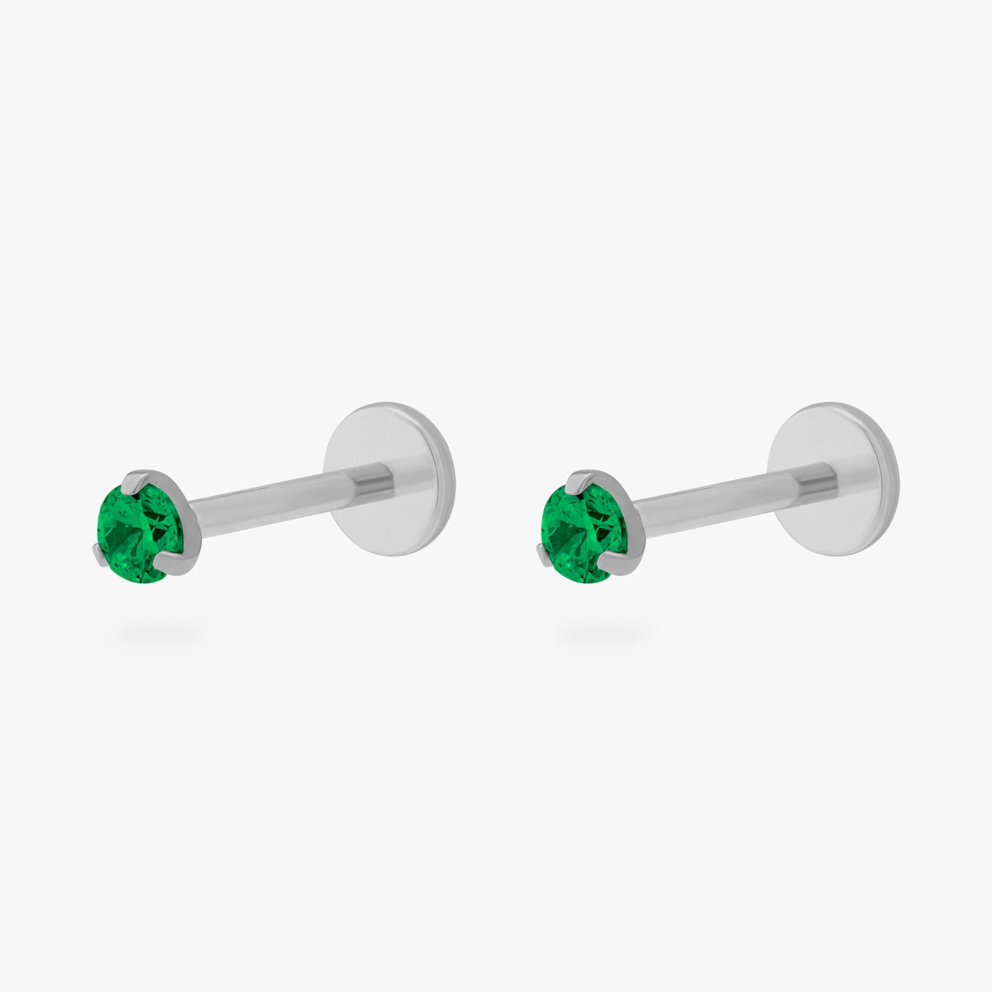 This is a pair of silver toned titanium flatback studs with mini emerald cz stones. [pair] color:null|emerald