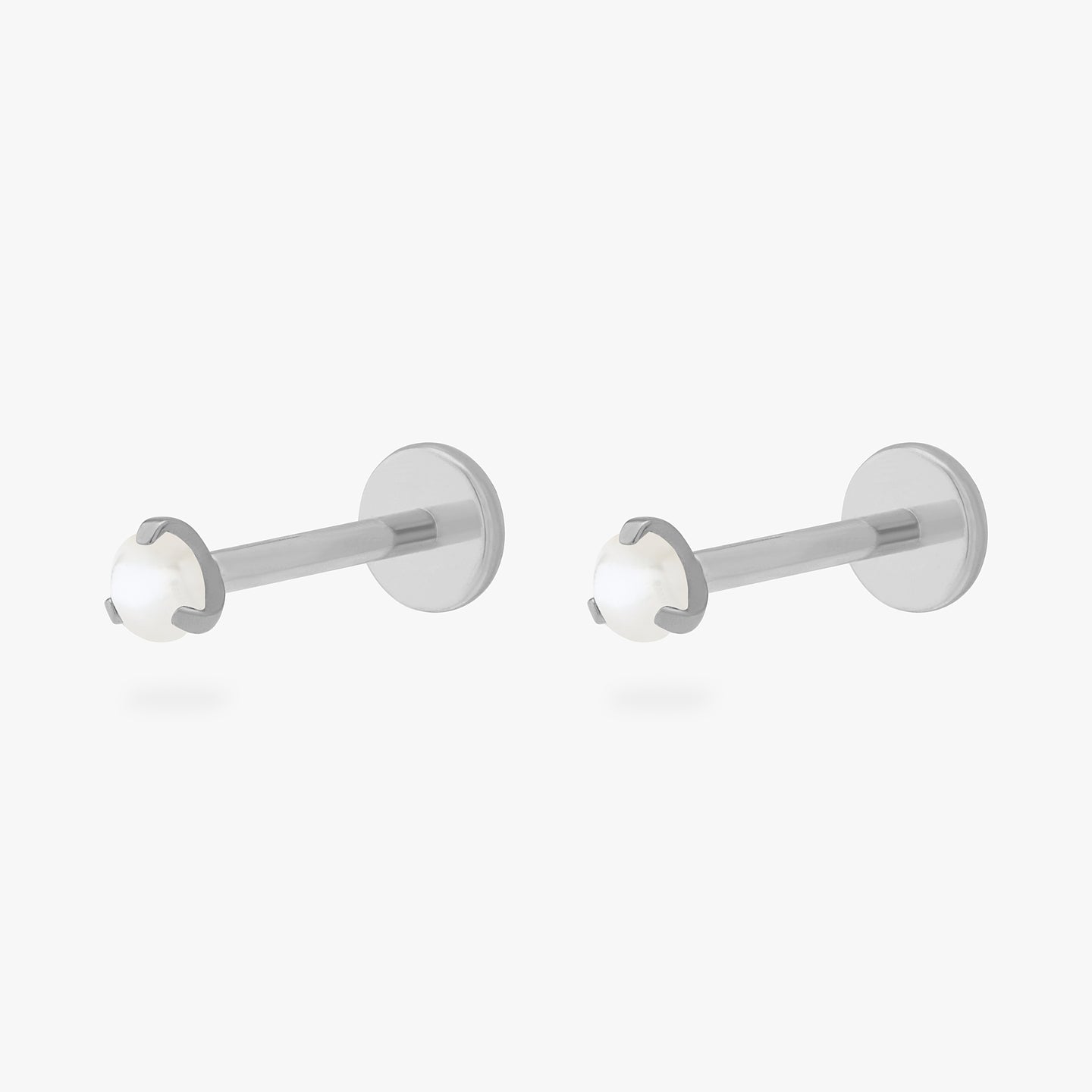 This is a pair of silver toned titanium flatback studs with mini pearl stones. [pair] color:null|pearl