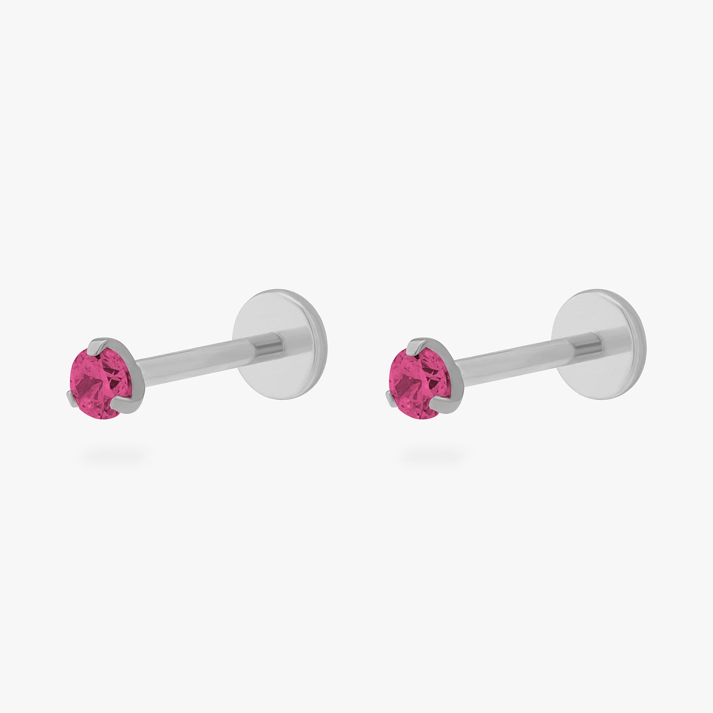 This is a pair of silver toned titanium flatback studs with mini ruby cz stones. [pair] color:null|ruby