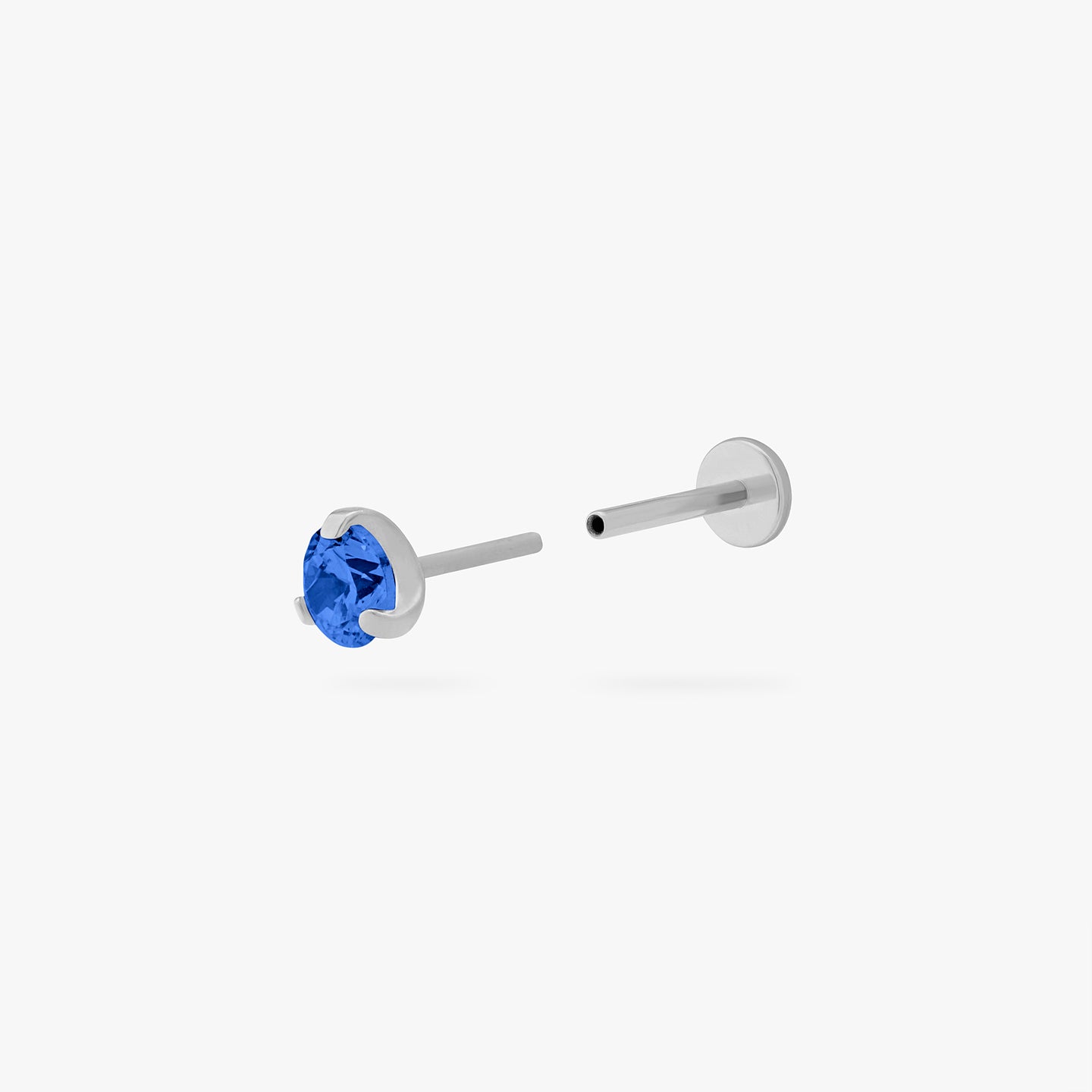 This is a silver toned titanium flatback stud with a mini sapphire cz stone. color:null|sapphire