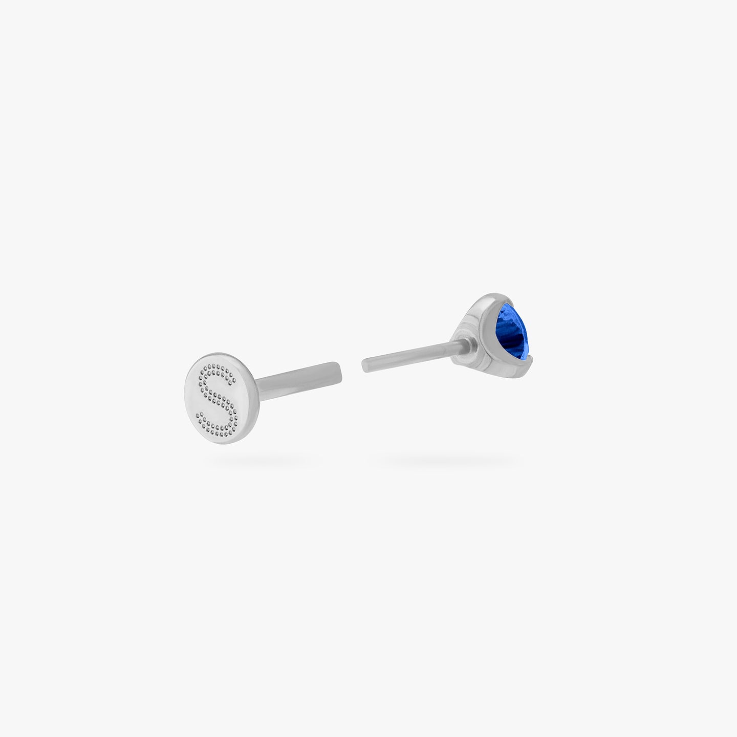 This is a silver toned titanium flatback stud with a mini sapphire cz stone. color:null|sapphire